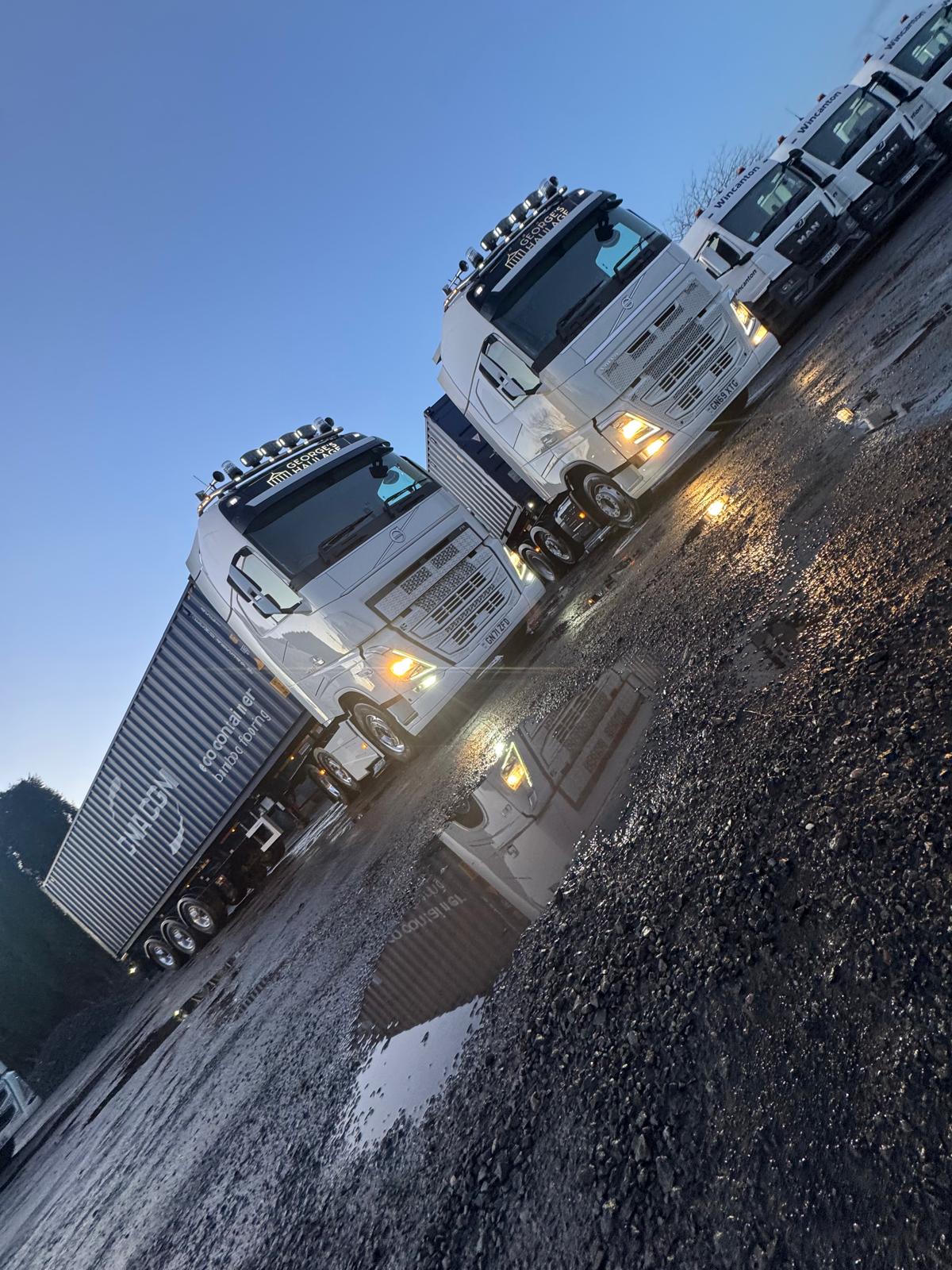 George's Haulage trucks lined up after dark